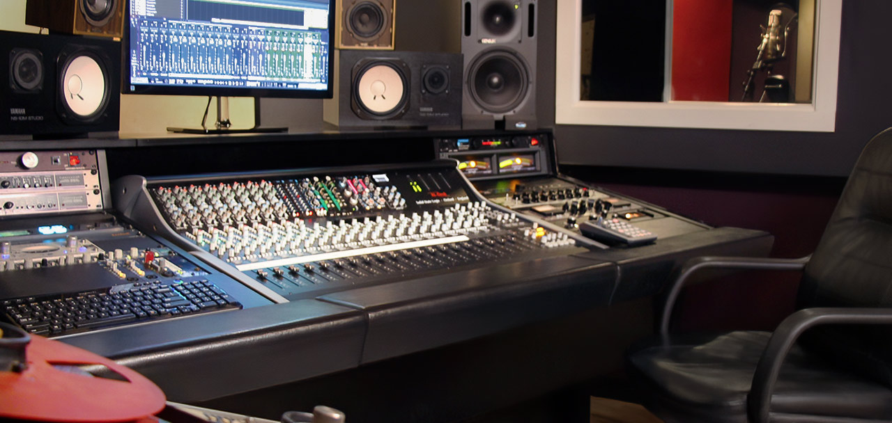View from the back of our control room with our Ampex ATR-102 in the foreground and a view into our vocal booth.